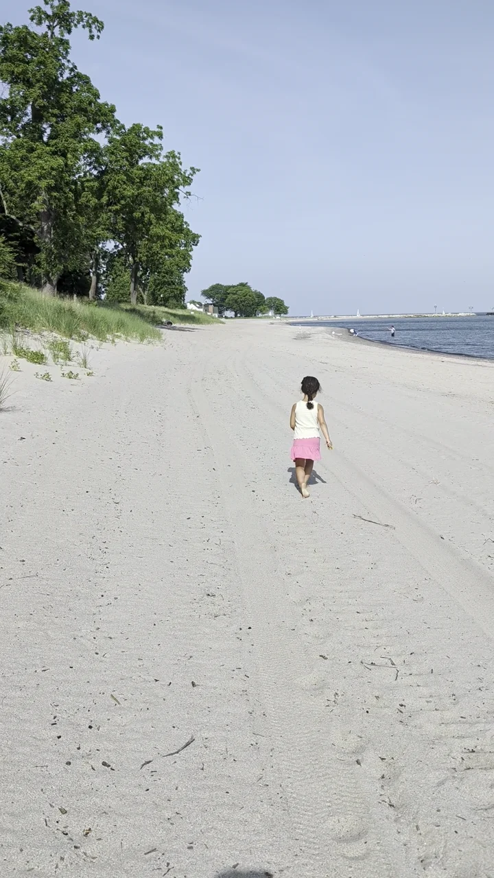 Kim’s daughter walking along a sandy beach during one of the family’s own outings.